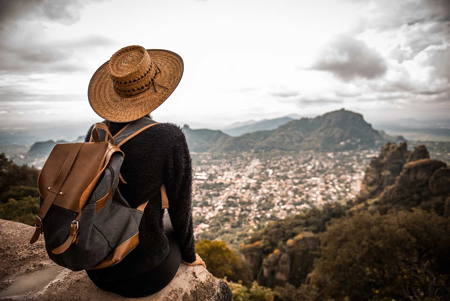 Traveler overlooking a scenic Latin American city from a mountaintop, symbolizing the cultural connection and flexibility of taking online Portuguese classes with Berlitz.

