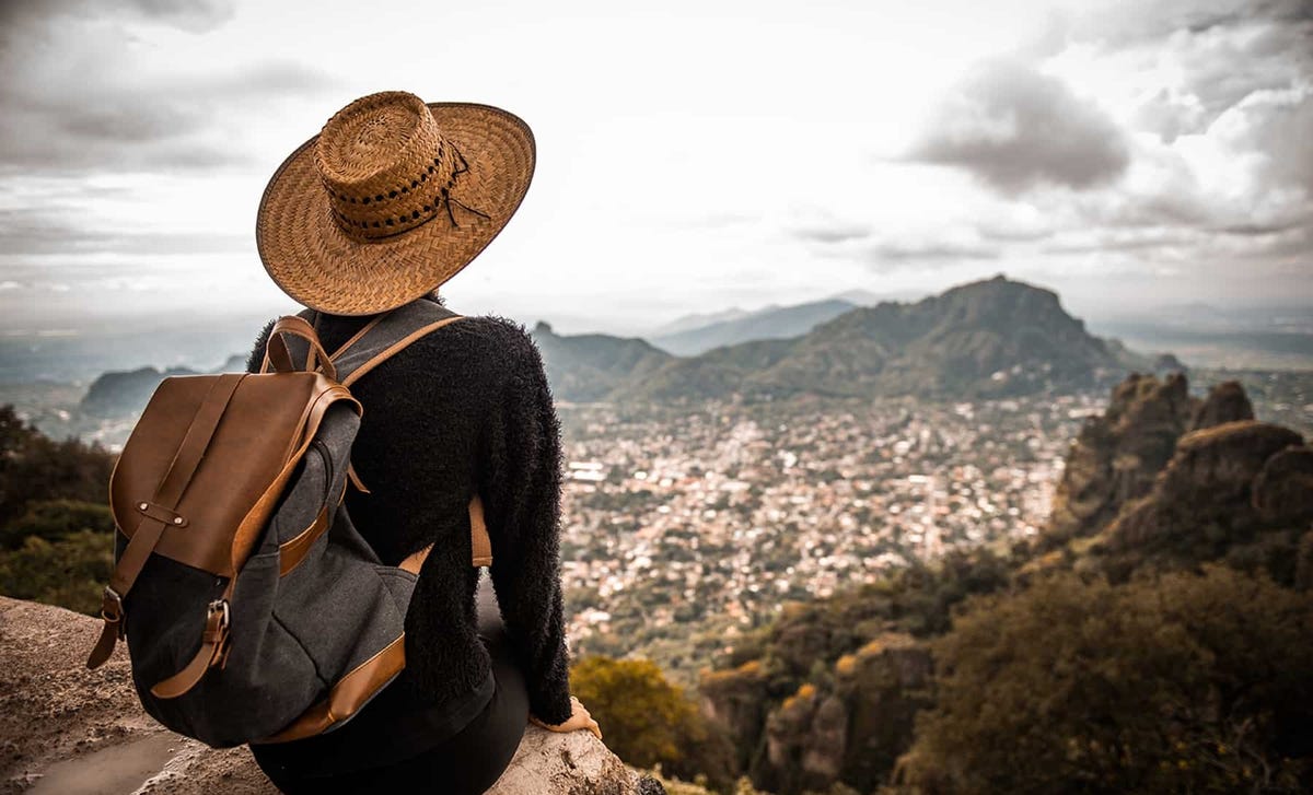 Traveler overlooking a scenic Latin American city from a mountaintop, symbolizing the cultural connection and flexibility of taking online Portuguese classes with Berlitz.
