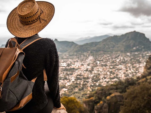 Traveler overlooking a scenic Latin American city from a mountaintop, symbolizing the cultural connection and flexibility of taking online Portuguese classes with Berlitz.