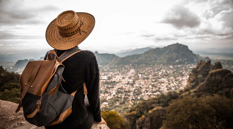 Traveler overlooking a scenic Latin American city from a mountaintop, symbolizing the cultural connection and flexibility of taking online Portuguese classes with Berlitz.