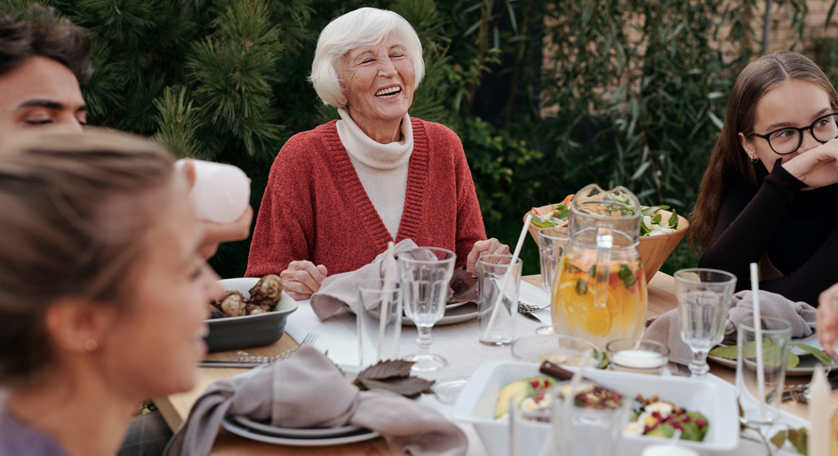 Woman sharing a meal with her family-in-laws in Italian.