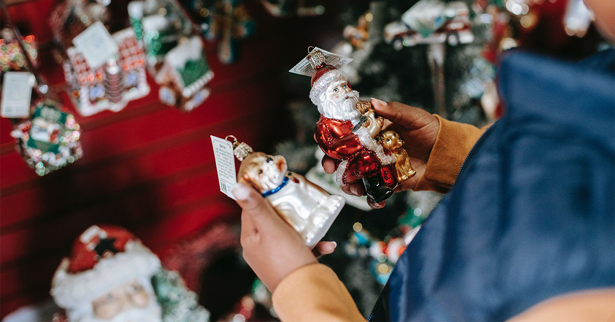 Boy chooses some Christmas decorations at a market in Germany.