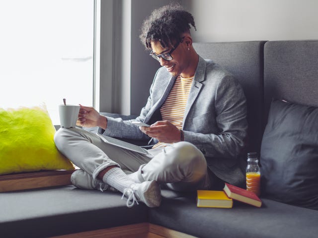 Man learning English online through private classes while relaxing at home