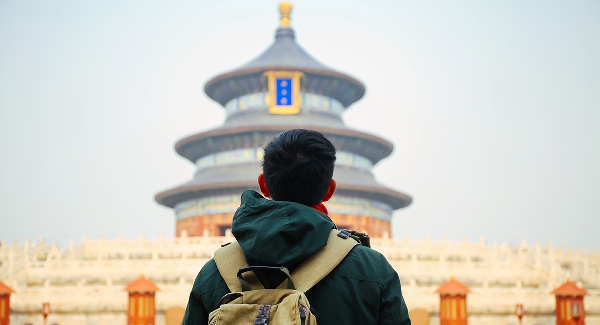 Man looking at the Beijing Temple of Heaven.