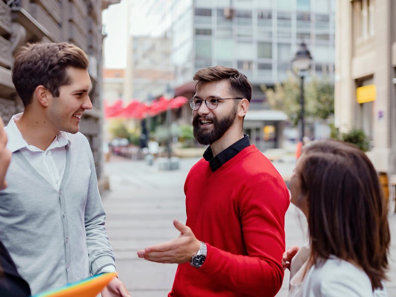 Group of young adults conversing in Croatian during a language course in an urban outdoor setting