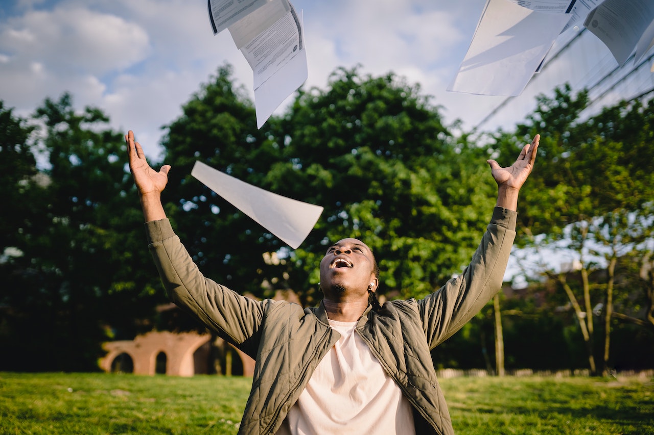 Happy student throws papers up into the air that contain the longest German words.