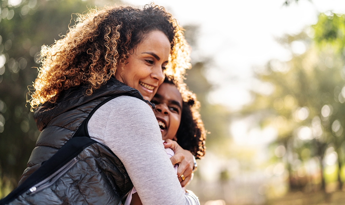 Mother and daughter share a hug.