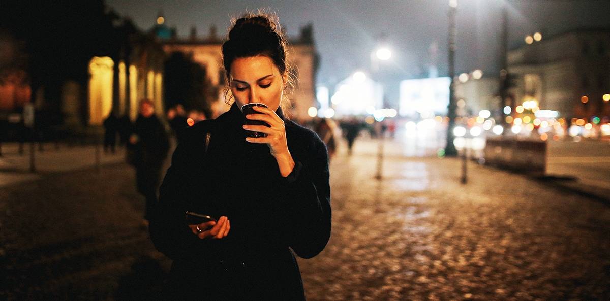 Woman on her mobile phone receiving news that is sad in German.