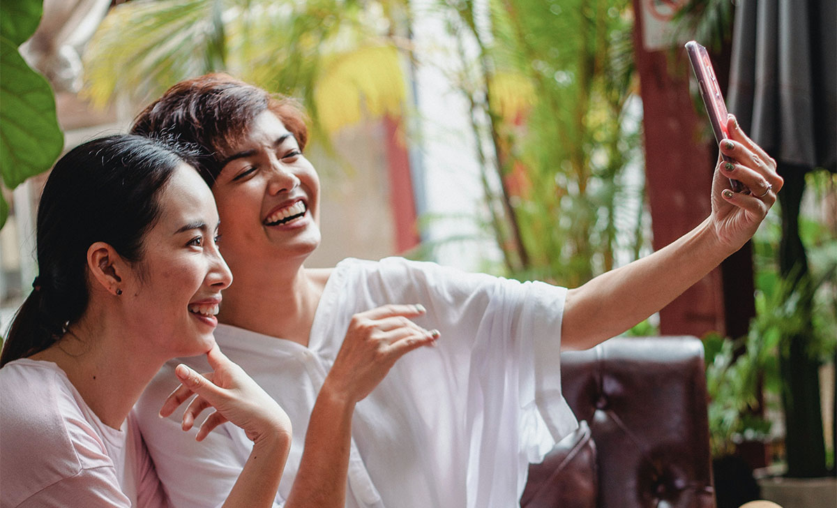 Two women taking a selfie to put on Chinese social media platforms.