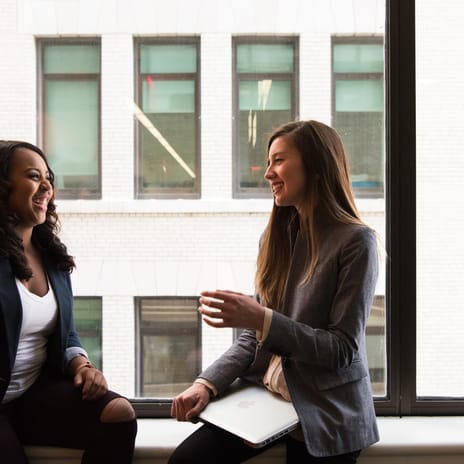 Two woman talking and laughing