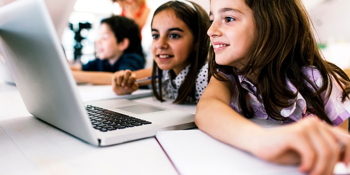 Two young students learning a language online.