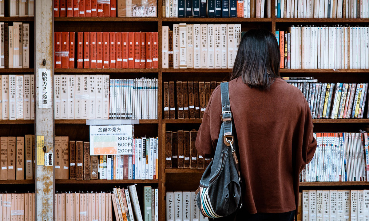 Woman reading Japanese literature at the library.