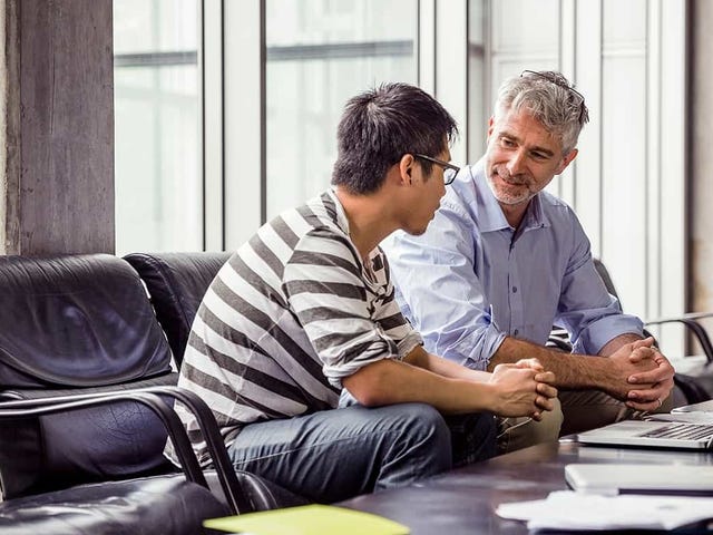 Professional language instructor mentoring an adult student in a one-on-one session, highlighting personalized learning available through Berlitz.com.