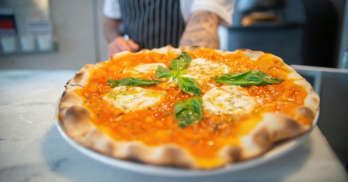 The Margherita Pizza was born in Naples to honor Queen Margherita, it displayed all the colors of the Italian flag, the red tomatoes, the white mozzarella, and the green basil.