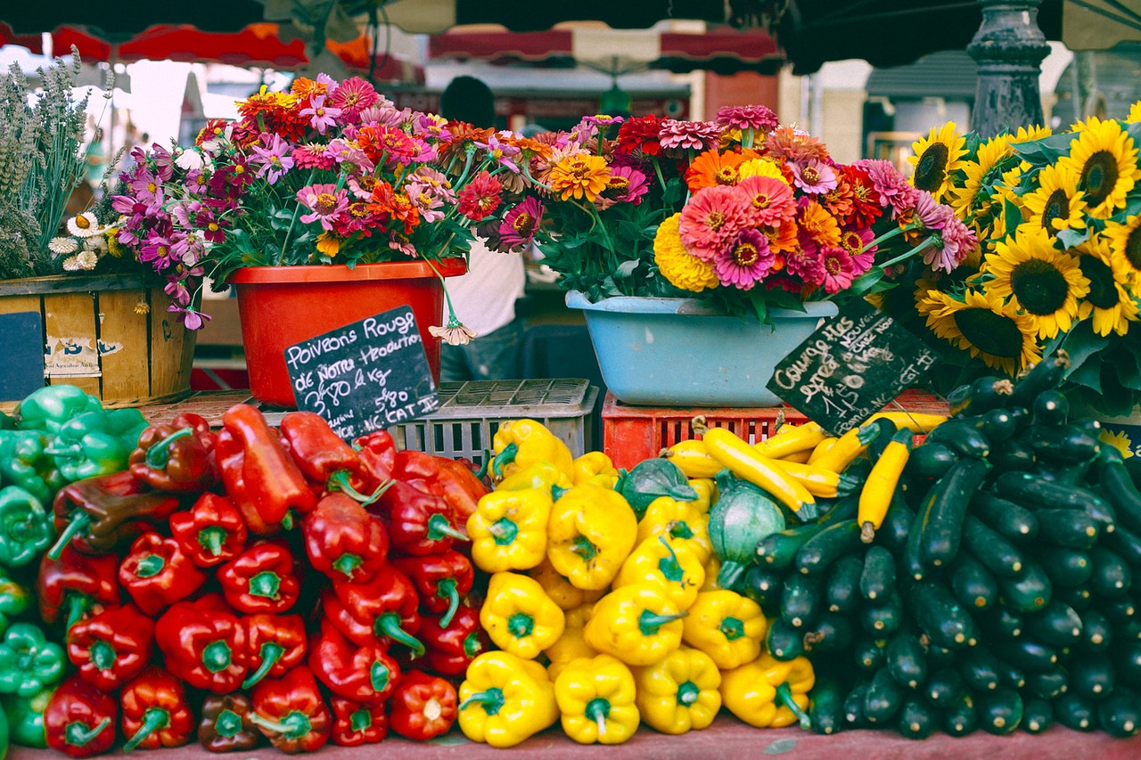 Beautiful colorful flowers, peppers at a French market with numbers and prices in euros