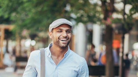 Confident man walking through the city, reflecting the real-world confidence gained from completing a Berlitz English course.