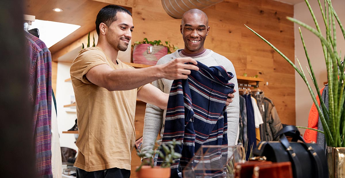 Two men enjoying clothes shopping in America.
