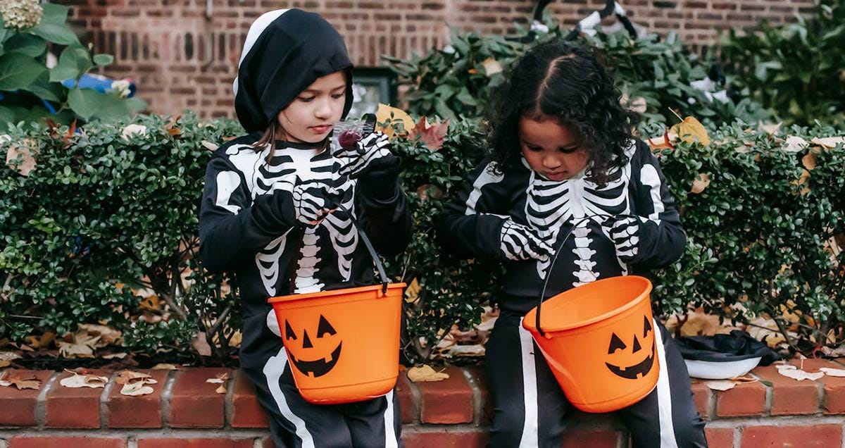 Children dressed as skeletons on Halloween.
