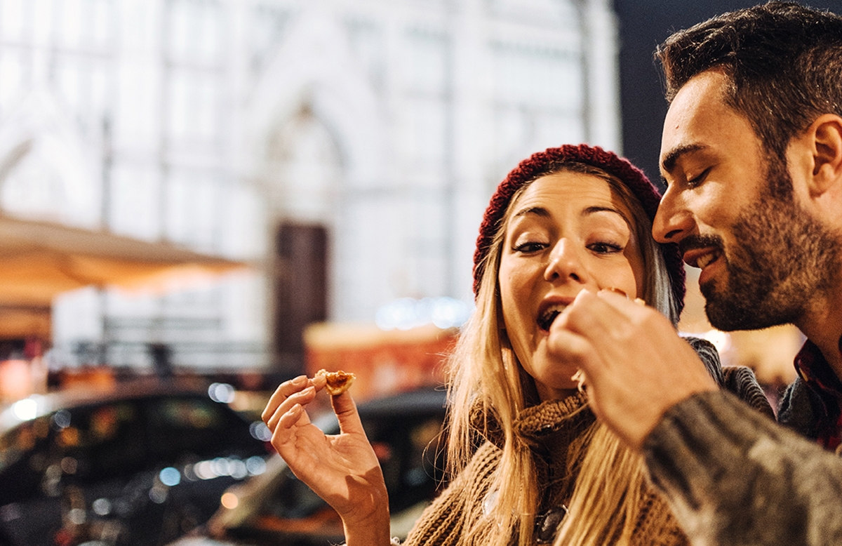 Couple sharing pizza is a way to say I love you in Italian.