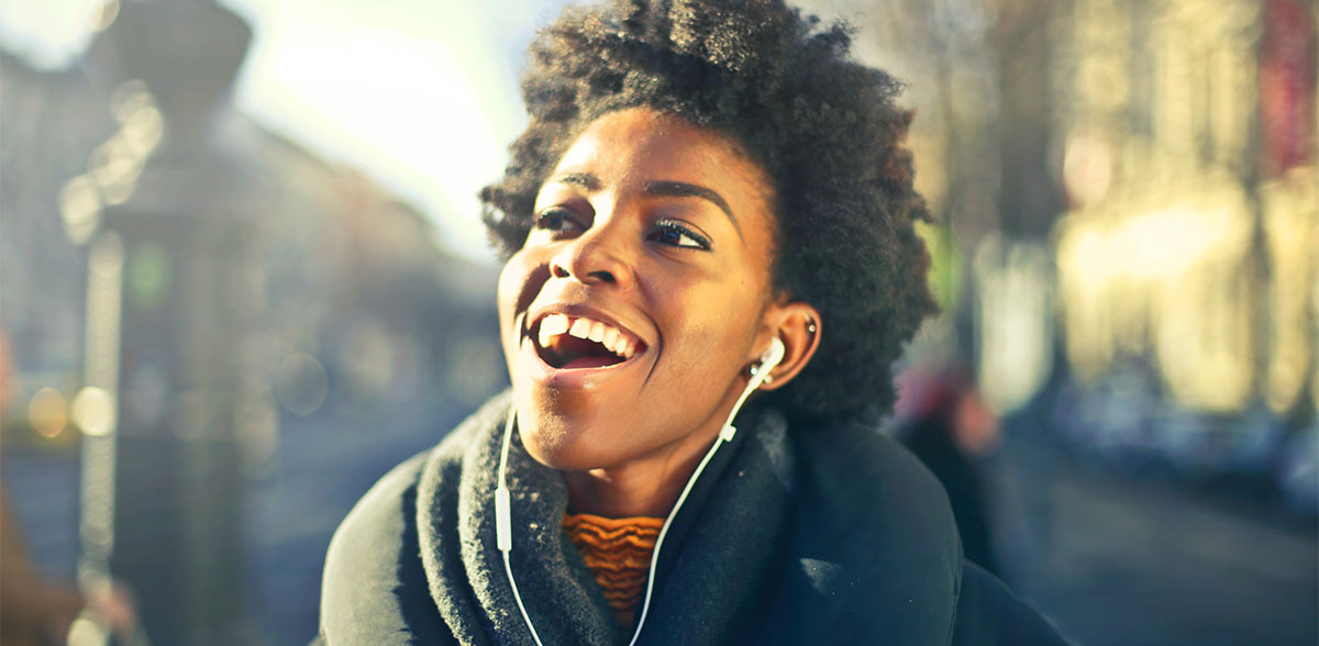 Woman with headphones listening to Latin American music.