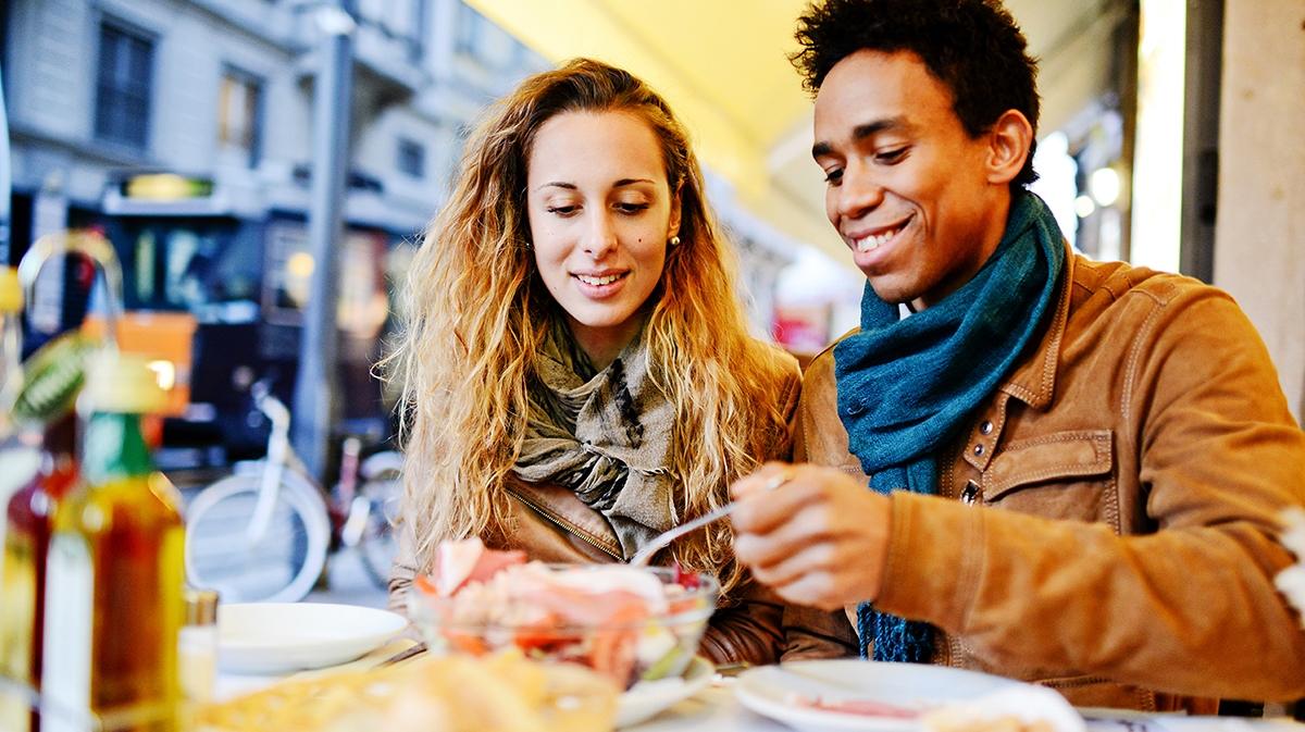 Friends enjoy practising their French at a cafe.