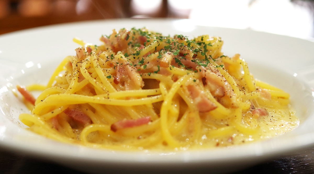 Spaghetti alla carbonara is made with pecorino cheese, raw eggs, guanciale, and black pepper.  No cream.