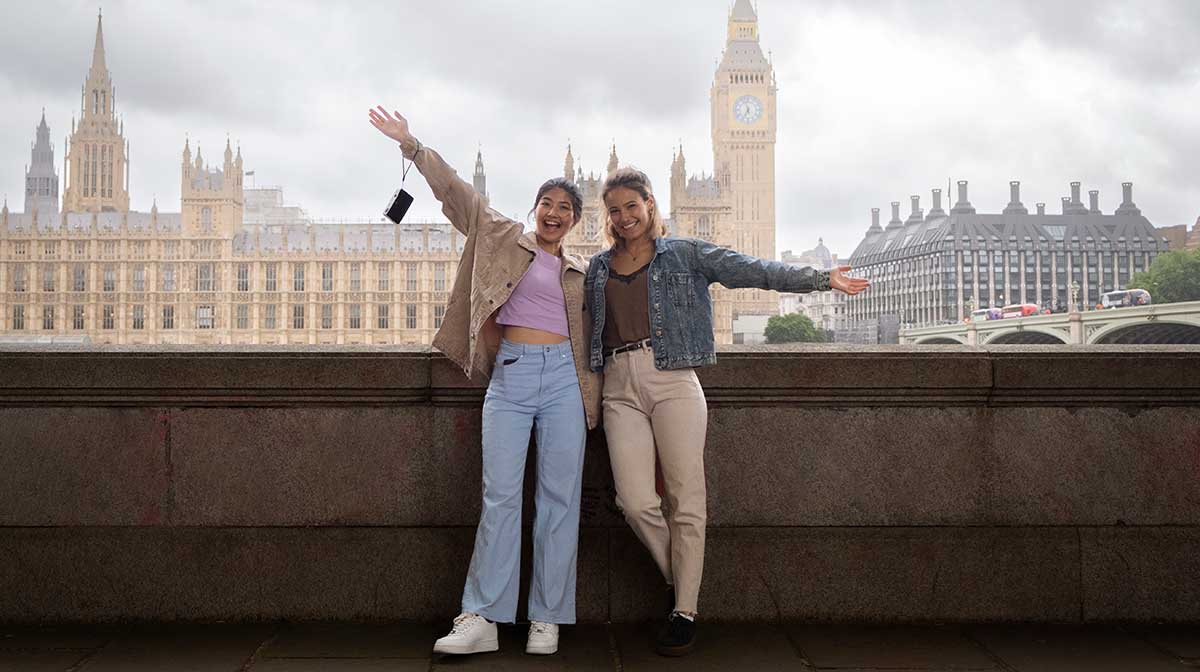 Two tourists posing for a photo in London.