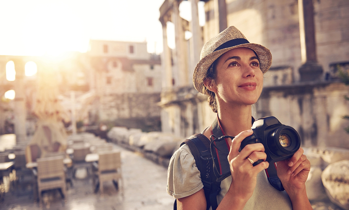 Woman taking photos during a holiday in Italy, where the scenery and beautiful Italian words are captivating.