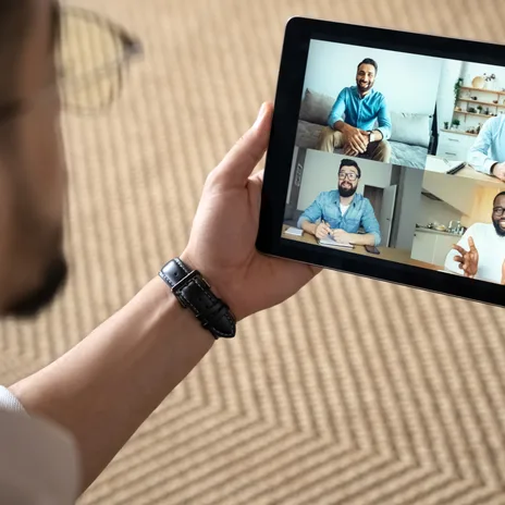 Man smiling on video call with Group Online Language Classes for Adults with Berlitz.