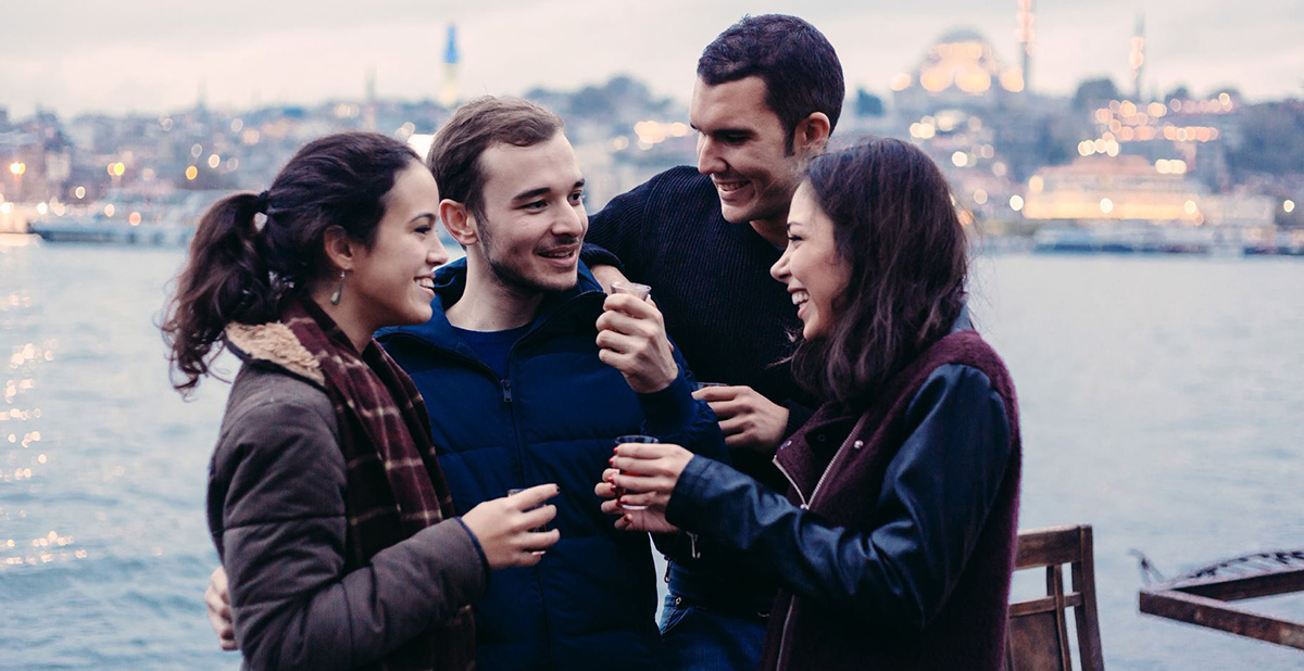 Friends laughing at funny Italian words and phrases.