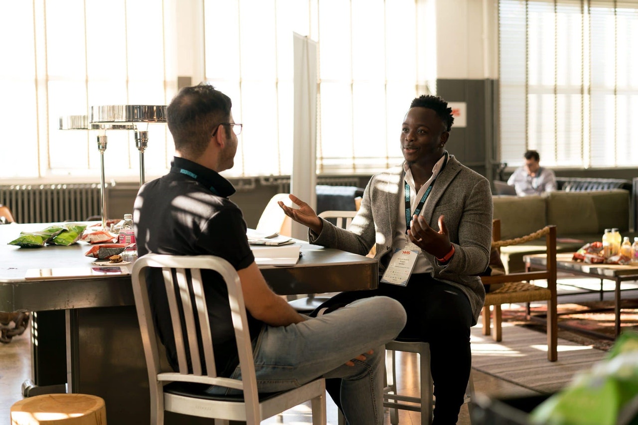 A man learning German alphabet pronunciation from a native fluent speaker.