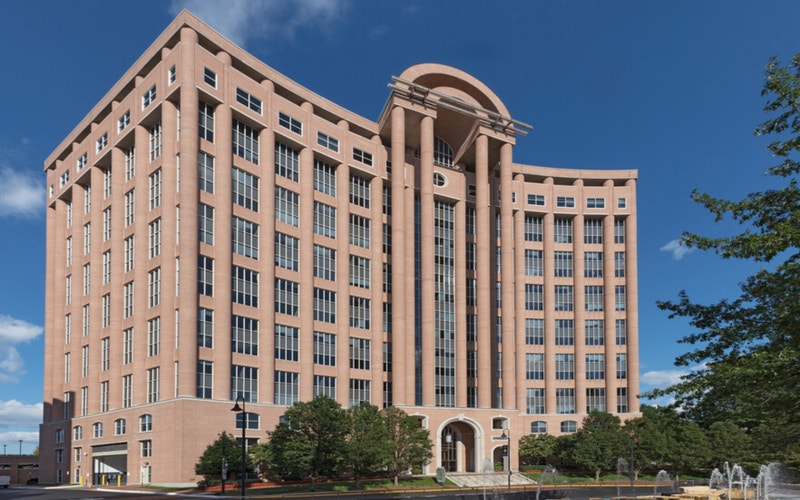 Berlitz Language Center in Tysons Corner, Virginia, housed in a modern office building with a curved facade and fountain in the foreground.
