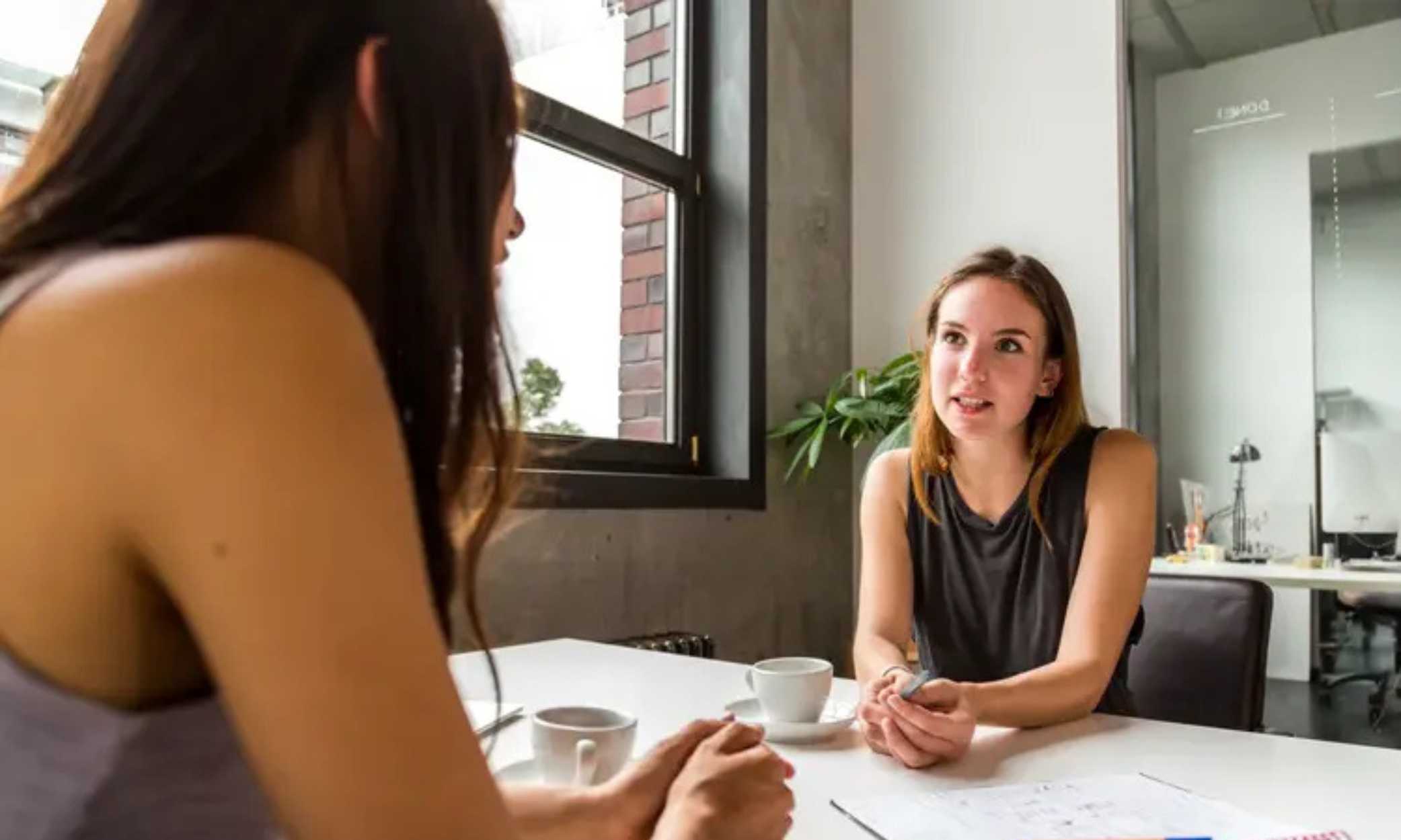Women conversing in a conference room