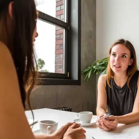 Women conversing in a conference room