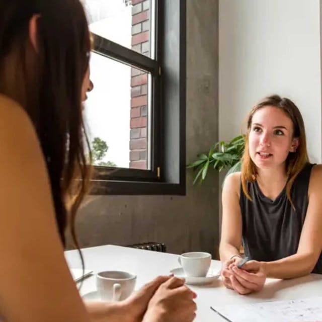 Women conversing in a conference room