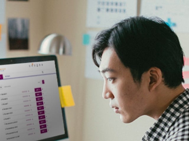 Man attending an english group class online through the Berlitz CyberTeachers platform at home.