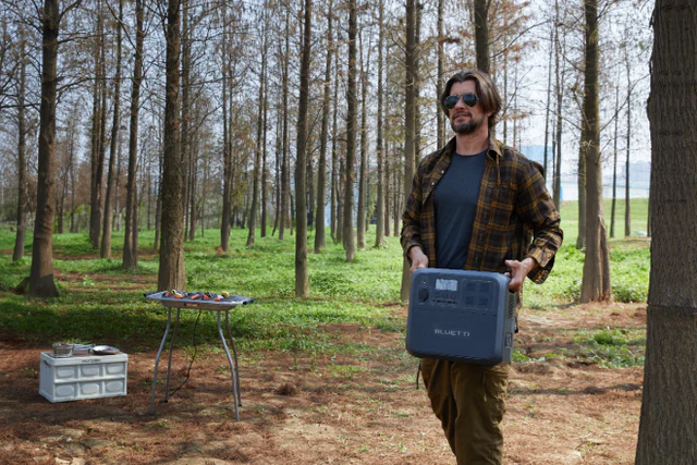 Carrying a BLUETTI power station through the forest
