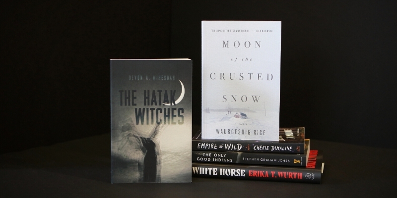 Five books arranged on a black backdrop.