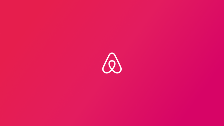 Airbnb logo on pink background