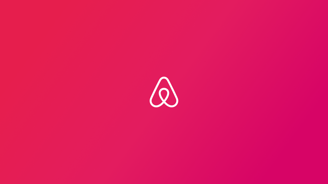 The Airbnb logo, the Airbnb Bélo, appears in white against a red background. 