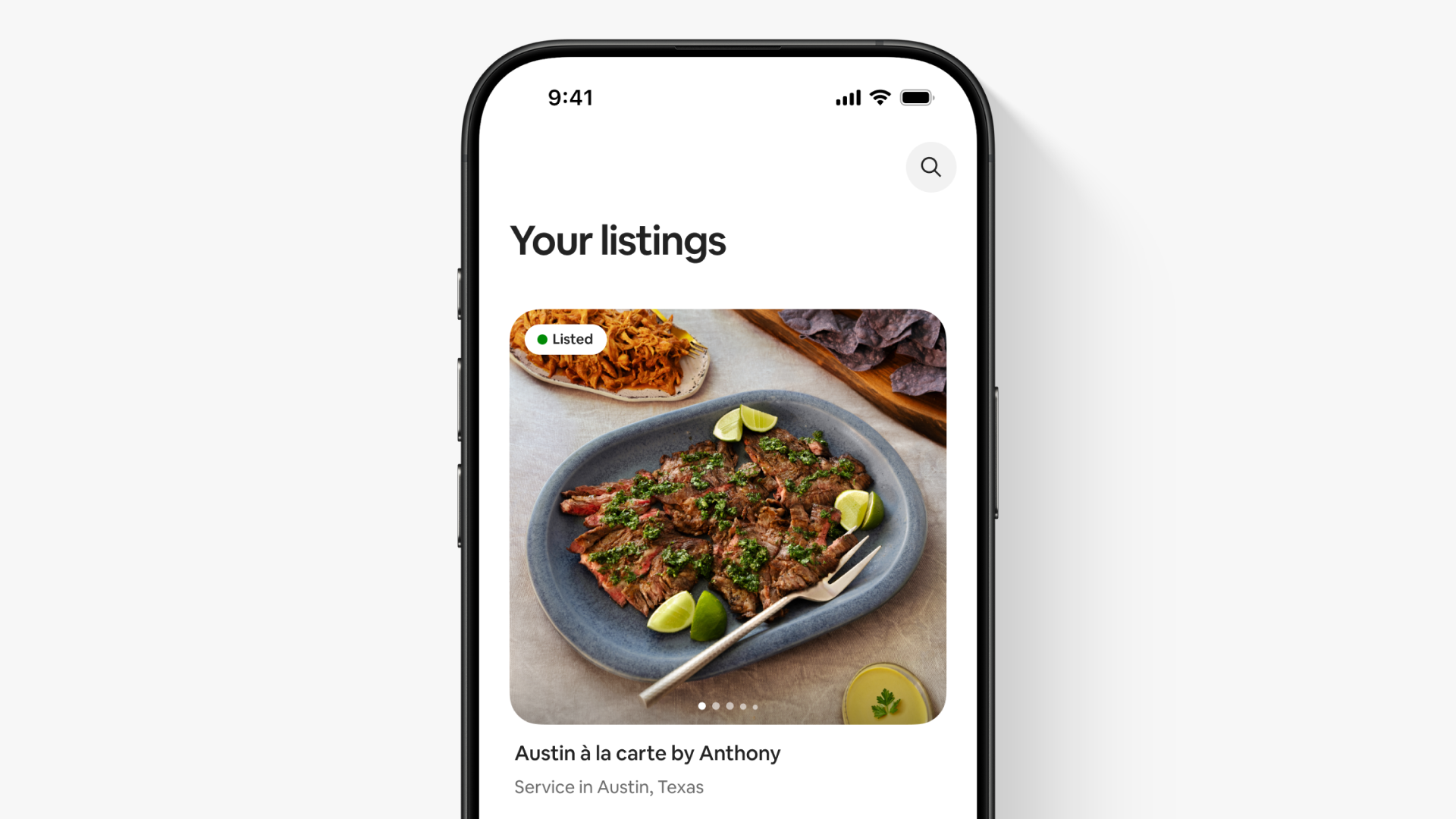 A screen in the Airbnb app shows a listing photo of a dish of food for a service called “Austin à la carte by Anthony.”