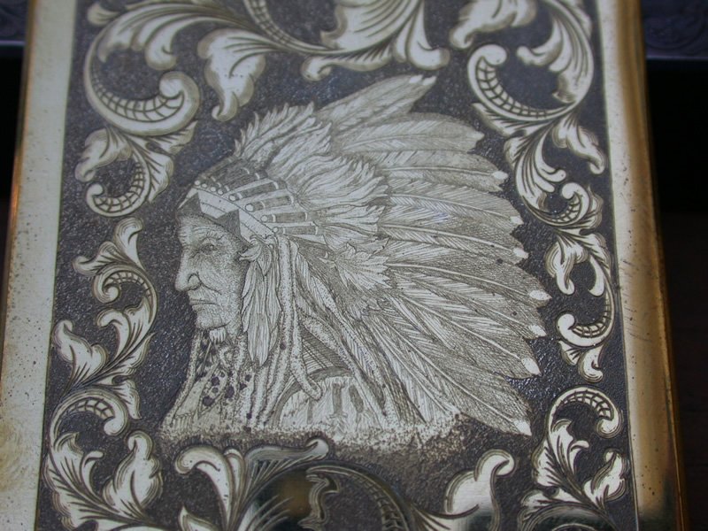 A gun handle engraved with an older Native American chief with full headdress using Bulino and traditional engraving 