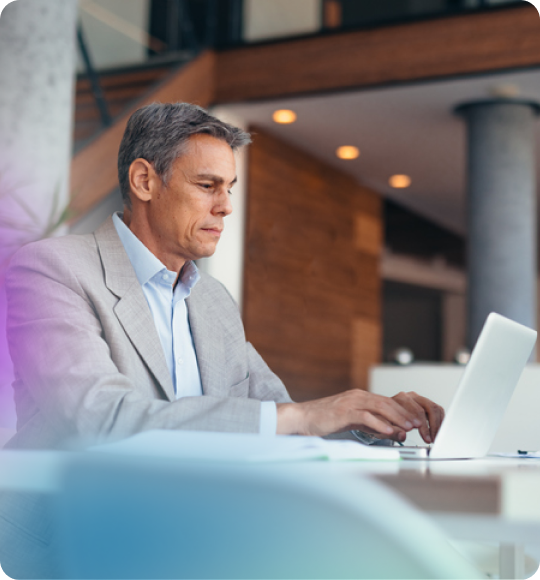 two people collaborating at a desktop computer