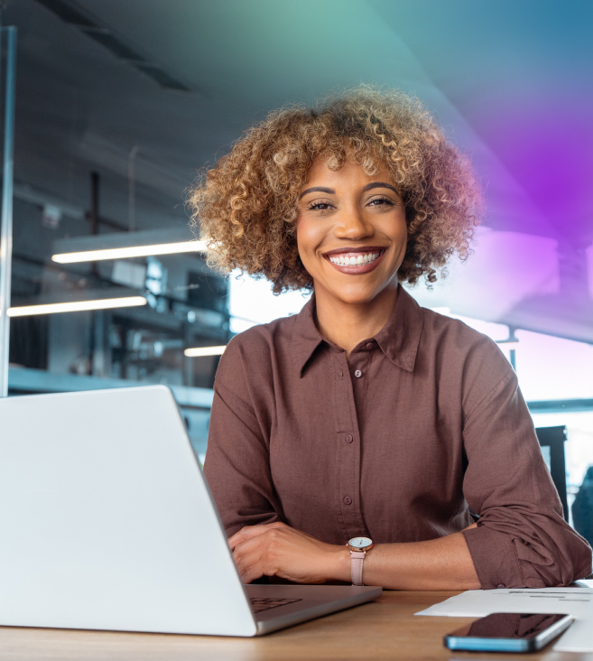 Woman smiling and looking at a laptop