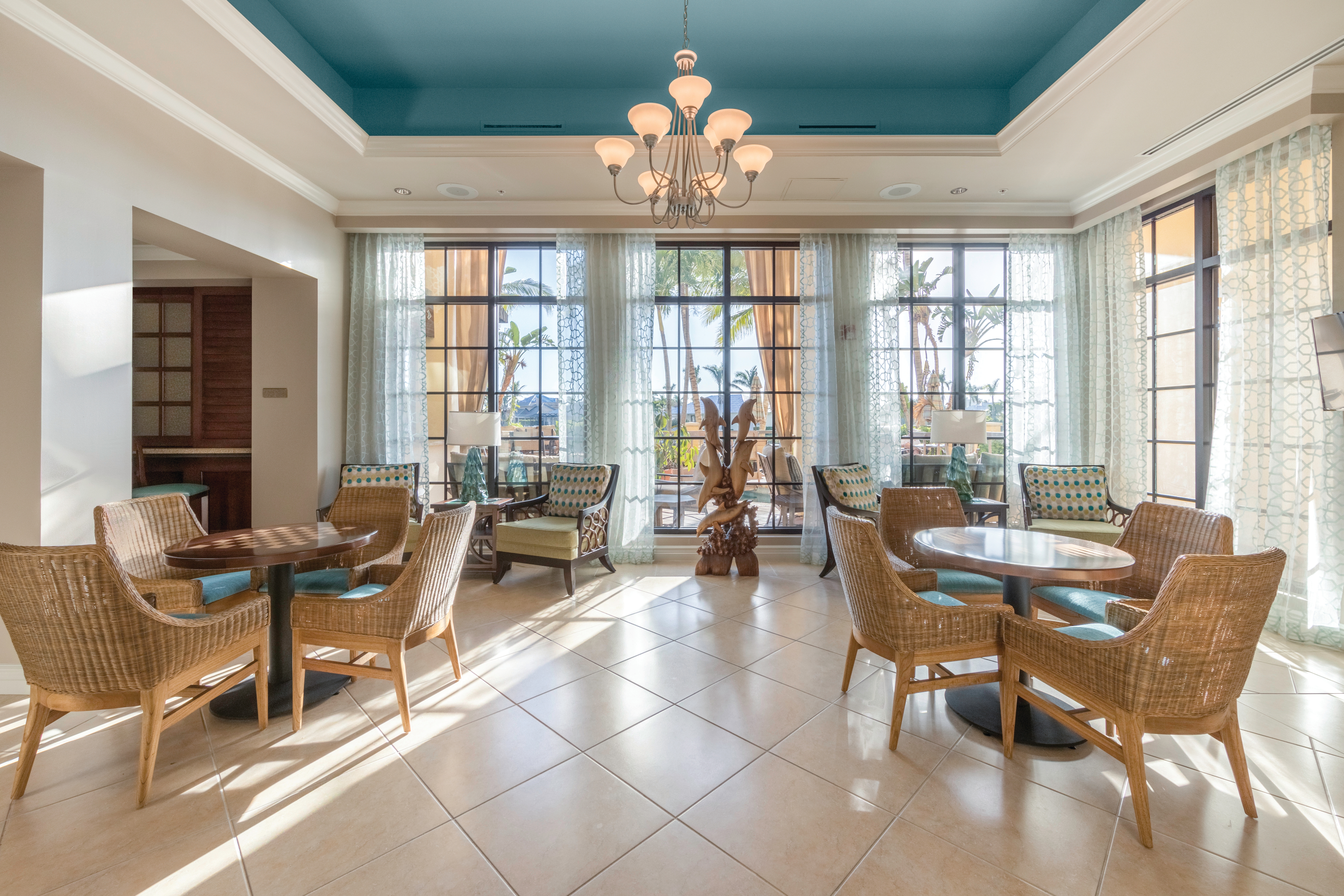 Lobby of Sunset Cove Resort with comfortable seating and coastal decor.