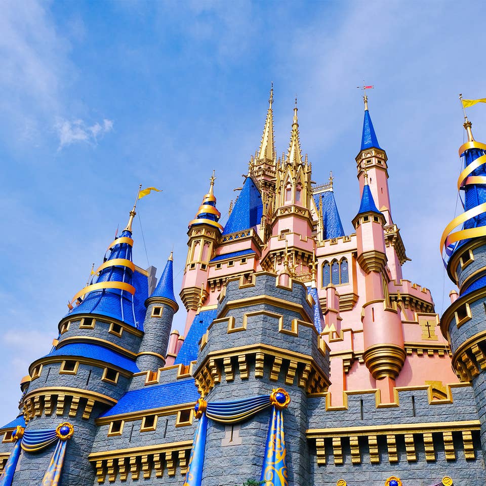 Cinderella's Castle at Magic Kingdom in Walt Disney World Resort is decorated in gold and blue ribbons for it's upcoming 50th Anniversary.