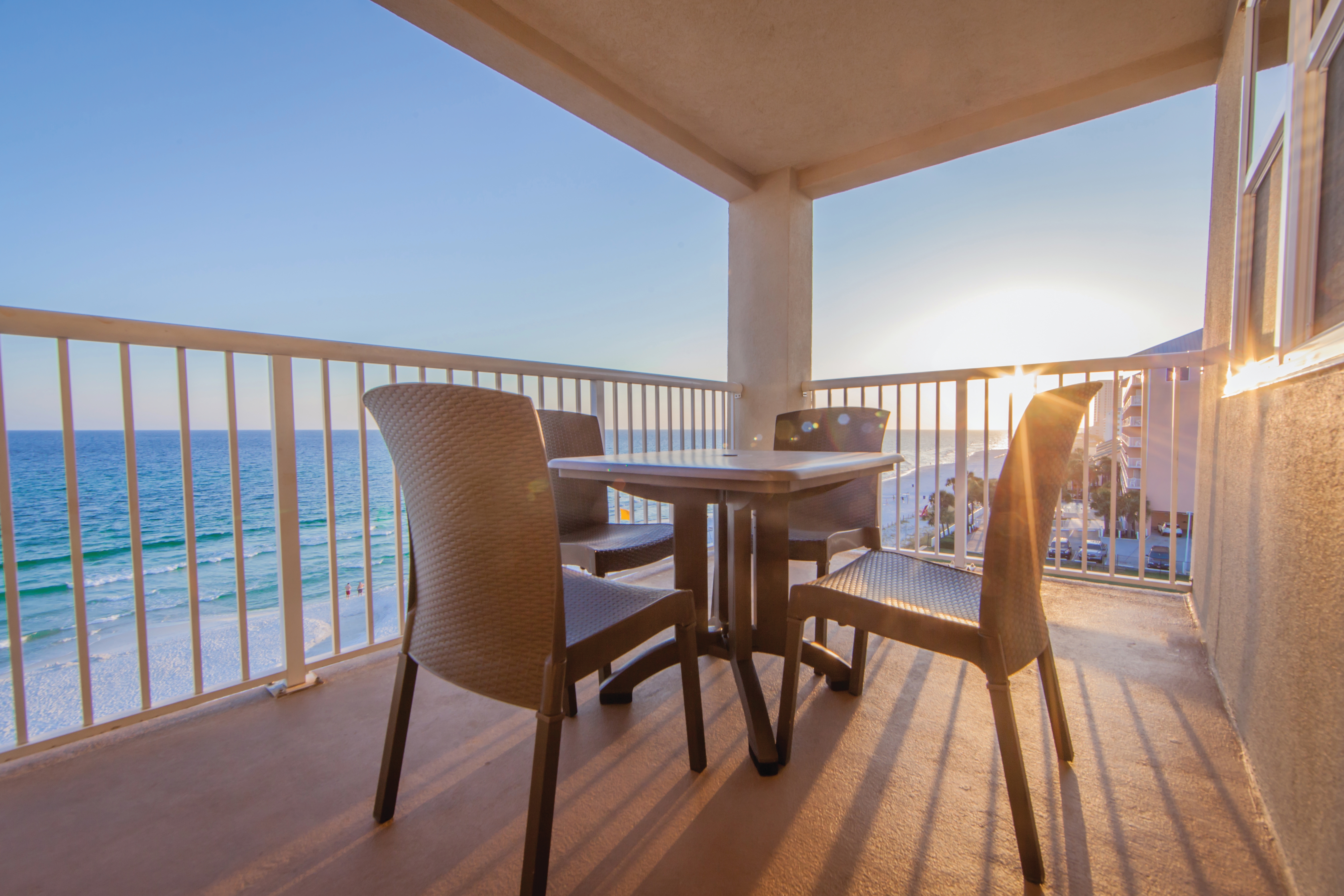 Furnished balcony with table and four chairs and view of ocean at Panama City Beach Resort