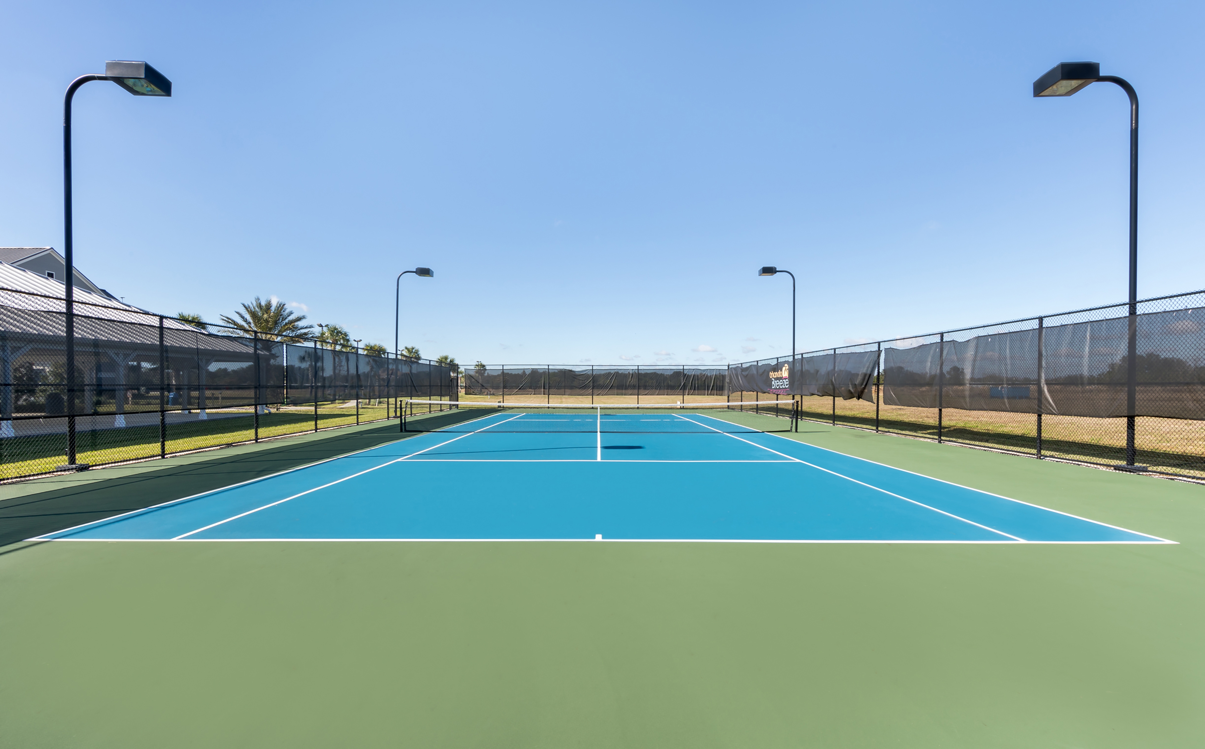 Outdoor tennis court at Orlando Breeze Resort in Florida.