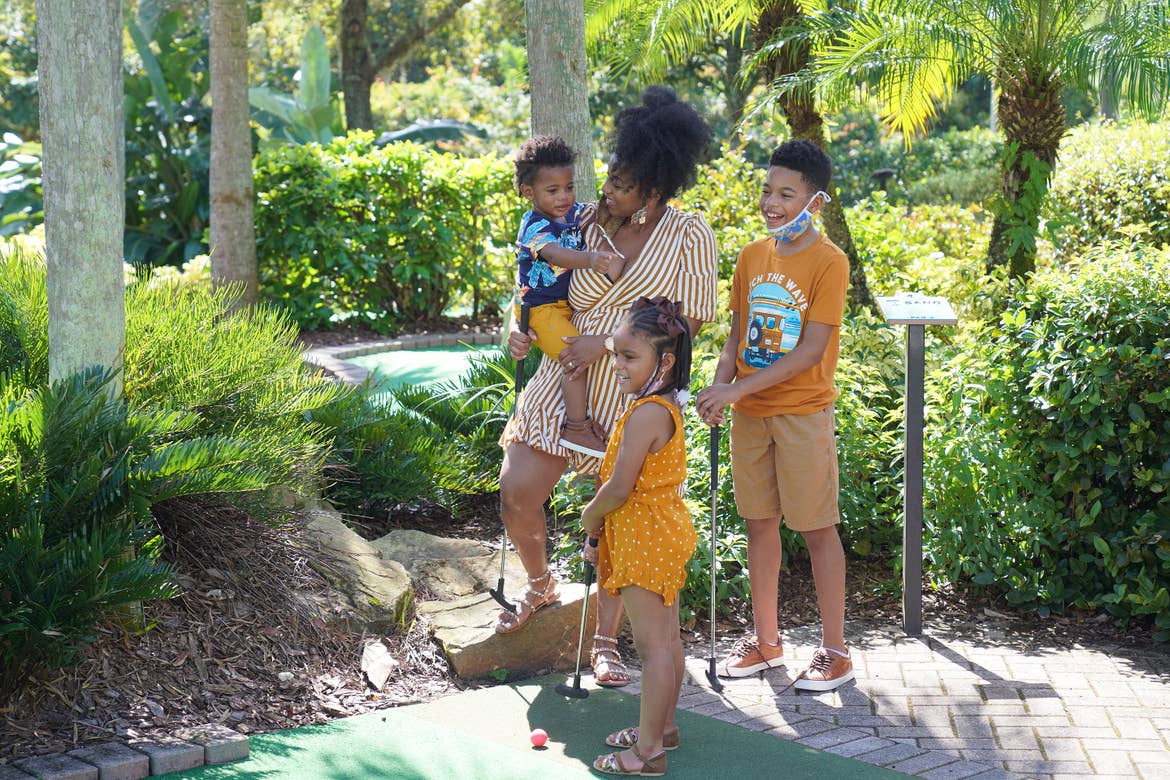 Featured Contributor, Tina Meeks, stands with her daughter and sons on the minature golf course of our Orange Lake resort in Orlando, Florida.