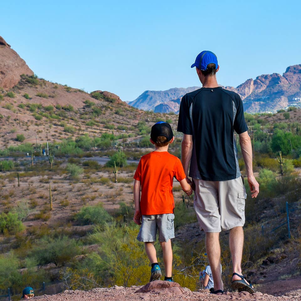 Jessica Averett's husband (right) and son (right) stand looking out at the McDowell Sonoran Preserve in Scottsdale, Arizona.